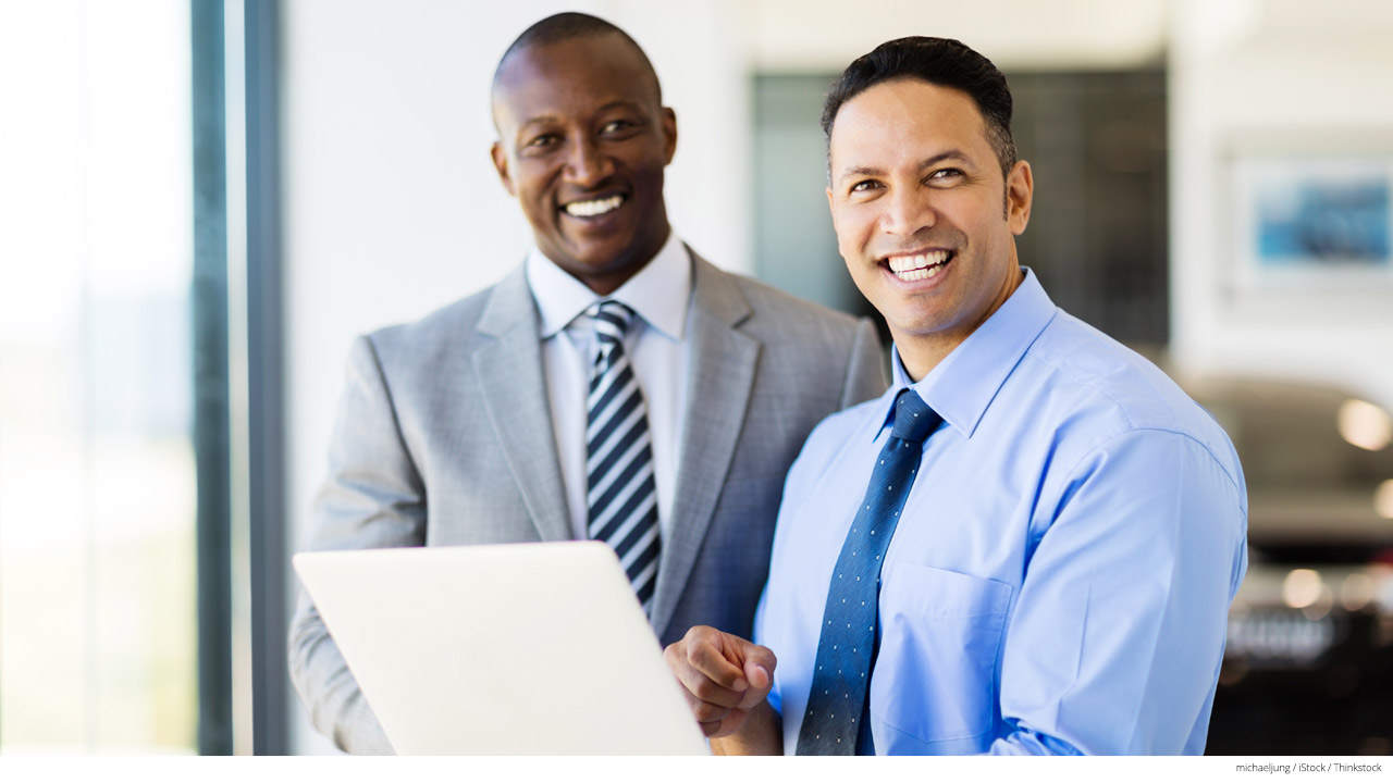 Agent showing businessman information on computer