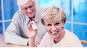 Portrait-of-senior-couple-seated-at-table-holding-pill-bottle-1024x576.jpg