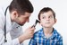 kid with health insurance getting examined by doctor