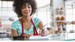 Smiling waitress writing on notepad