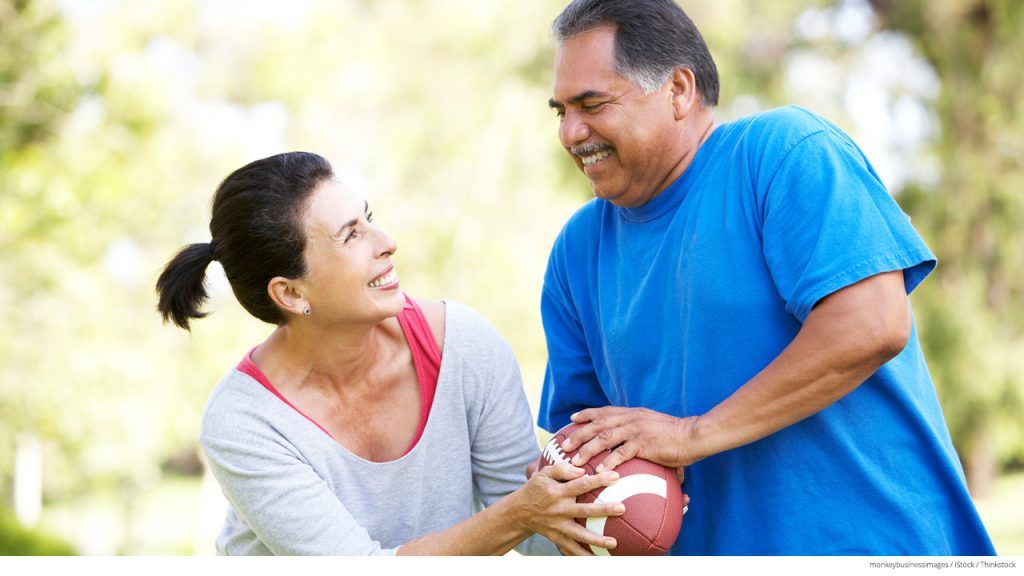 Senior couple playing with football