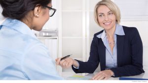 Senior business woman in interview with a trainee - application