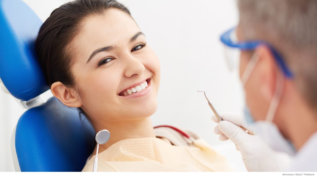 Girl getting teeth cleaned at dentist