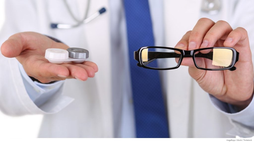 Doctor holding contact case and glasses