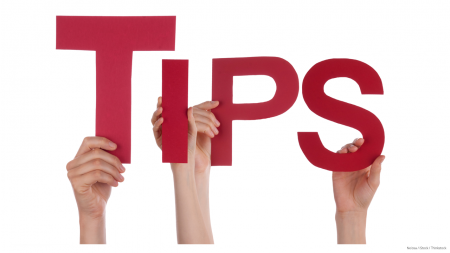 Hands holding up red letters that spell out “TIPS”
