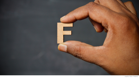 Hand holding the letter F; medicare plan f