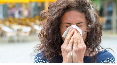 Woman blowing nose