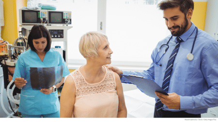 Doctor reviewing diagnosis with patient while nurse is in the room