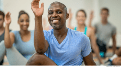 Man doing stretches in Yoga class