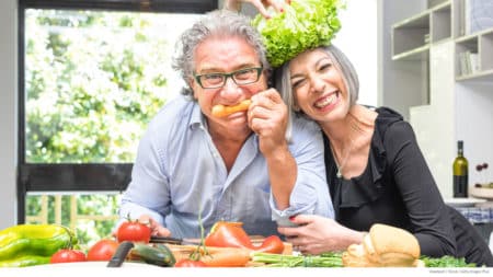 Senior couple having fun preparing healthy meal